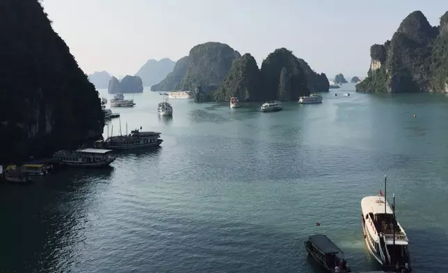 FILE - Tourist boats move in Ha Long Bay in Vietnam on Oct. 24, 2015. (AP Photo/Huy Han)