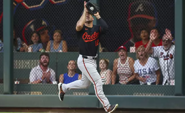 Baltimore Orioles outfielder Ramón Laureano (12) makes a catch in the third inning of a baseball game against the Atlanta Braves, Friday, July 4, 2025, in Atlanta. (AP Photo/Colin Hubbard)