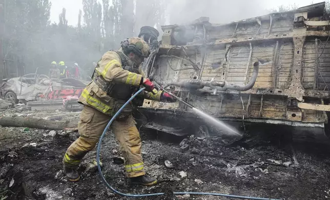Firefighters work to extinguish a fire after a Russian missile attack in Kyiv, Ukraine, Thursday, July 31, 2025. (AP Photo/Efrem Lukatsky)