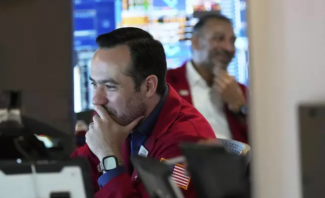 Robert Greason works on the floor at the New York Stock Exchange in New York, Monday, July 14, 2025. (AP Photo/Seth Wenig)