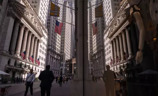 A reflection of a window shows the New York Stock Exchange on Monday, June 30, 2025, in New York. (AP Photo/Yuki Iwamura)
