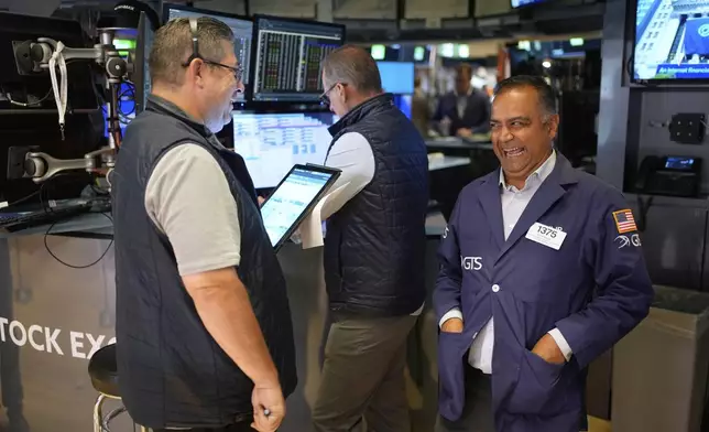 Dilip Patel laughs while working on the floor at the New York Stock Exchange in New York, Monday, July 14, 2025. (AP Photo/Seth Wenig)