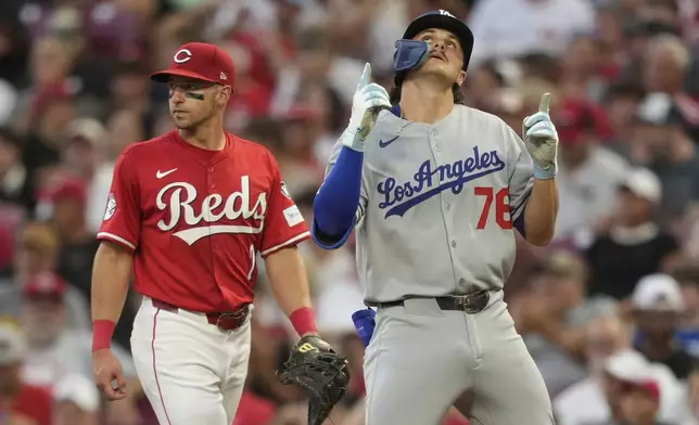 Los Angeles Dodgers' Alex Freeland reacts after hittting his first major league hit during the fifth inning of a baseball game against the Cincinnati Reds Wednesday, July 30, 2025, in Cincinnati. (AP Photo/Carolyn Kaster)