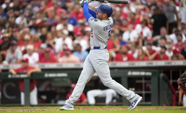 Los Angeles Dodgers' Freddie Freeman hits a a two-run home run during the third inning of a baseball game Wednesday, July 30, 2025, in Cincinnati. (AP Photo/Carolyn Kaster)