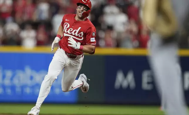 Cincinnati Reds' Spencer Steer hits a two-run scring triple during the eighth inning of a baseball game against the Los Angeles Dodgers Wednesday, July 30, 2025, in Cincinnati. (AP Photo/Carolyn Kaster)