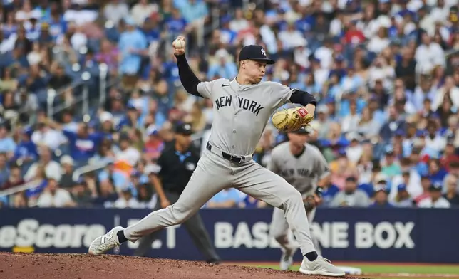 New York Yankees pitcher Will Warren (98) throws a pitch against the Toronto Blue Jays during the first inning of a baseball game in Toronto, Wednesday, July 2, 2025. (Sammy Kogan/The Canadian Press via AP)