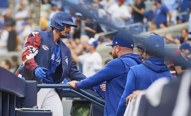 Toronto Blue Jays' Addison Barger (47) celebrates with his team after hitting a three-run home run against the New York Yankees during the first inning of a baseball game in Toronto, Wednesday, July 2, 2025. (Sammy Kogan/The Canadian Press via AP)