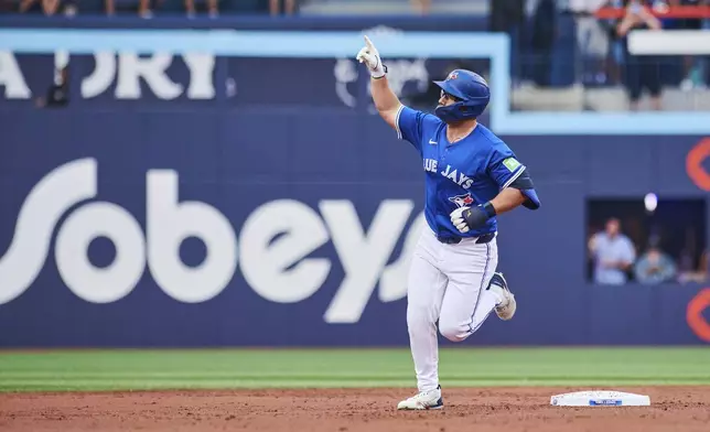 Toronto Blue Jays' Davis Schneider (36) reacts as he rounds the bases after hitting a two-run home run against the New York Yankees during the first inning of a baseball game in Toronto, Wednesday, July 2, 2025. (Sammy Kogan/The Canadian Press via AP)