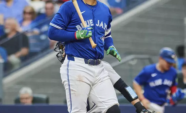 Toronto Blue Jays designated hitter George Springer (4) reacts after a strike by New York Yankees pitcher Will Warren (98) during the first inning of a baseball game in Toronto, Wednesday, July 2, 2025. (Sammy Kogan/The Canadian Press via AP)