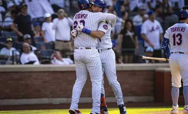 New York Mets' Jeff McNeil (1) celebrates after scoring on his two-run with Pete Alonso (20) during the seventh inning of a baseball game against the New York Yankees, Friday, July 4, 2025, in New York. (AP Photo/Angelina Katsanis)