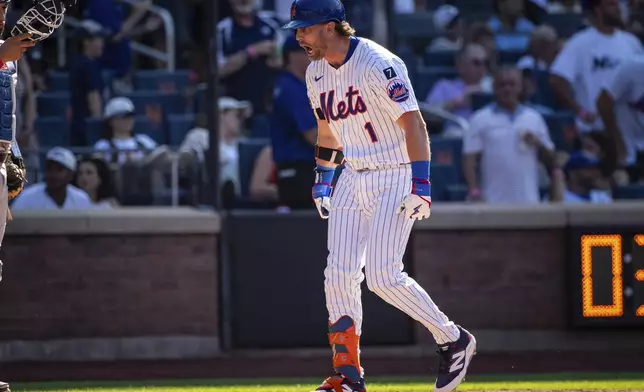 New York Mets' Jeff McNeil celebrates after scoring on his two-run during the seventh inning of a baseball game against the New York Yankees, Friday, July 4, 2025, in New York. (AP Photo/Angelina Katsanis)