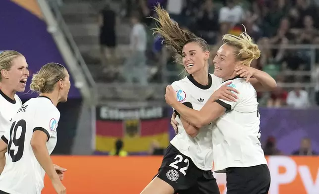Germany's Jule Brand, 2nd right, celebrates after scoring the opening goal during the Euro 2025, group C, soccer match between Germany and Poland at Arena St. Gallen in St. Gallen, Switzerland, Friday, July 4, 2025. (AP Photo/Martin Meissner)