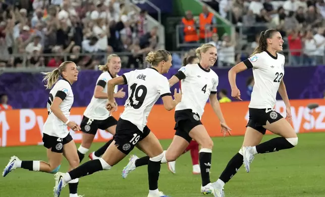 Germany's Jule Brand, right, celebrates after scoring the opening goal during the Euro 2025, group C, soccer match between Germany and Poland at Arena St. Gallen in St. Gallen, Switzerland, Friday, July 4, 2025. (AP Photo/Martin Meissner)