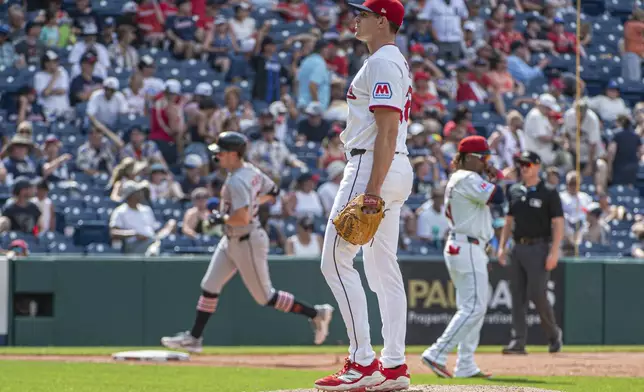 Cleveland Guardians relief pitcher Cade Smith, foreground, looks to home plate as Detroit Tigers' Trey Sweeney, back left, rounds the bases after hitting a three-run home run inning of a baseball game, Sunday, July 6, 2025, in Cleveland. (AP Photo/Phil Long)