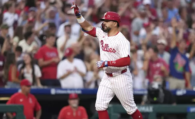 Philadelphia Phillies' Kyle Schwarber reacts after hitting a grand slam against Los Angeles Angels pitcher José Fermin during the sixth inning of a baseball game Saturday, July 19, 2025, in Philadelphia. (AP Photo/Matt Slocum)