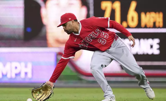 Los Angeles Angels first base LaMonte Wade Jr. fields a single by Philadelphia Phillies' J.T. Realmuto during the sixth inning of a baseball game Saturday, July 19, 2025, in Philadelphia. (AP Photo/Matt Slocum)