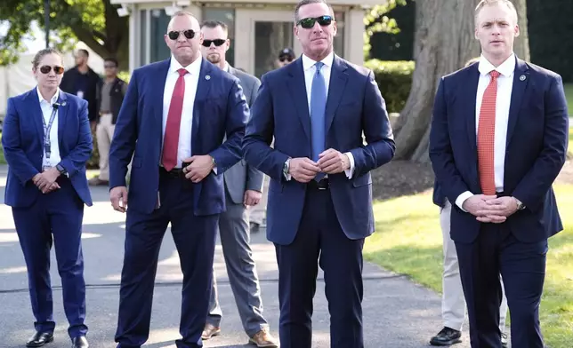 U.S. Secret Service Director Sean Curran, second from right, looks on as President Donald Trump and first lady Melania Trump address active-duty military service members and their families during a Fourth of July celebration on the South Lawn of the White House in Washington, Friday, July 4, 2025. (AP Photo/Alex Brandon, Pool)
