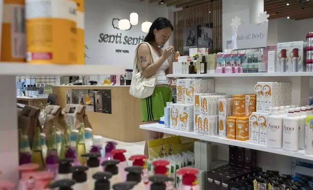 A customer checks out Asian beauty products at Senti Senti in New York on Friday, July 25, 2025. (AP Photo/Yuki Iwamura)