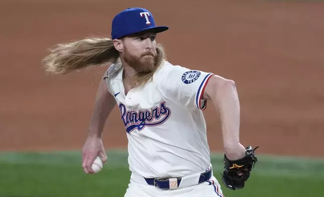 Texas Rangers relief pitcher Jon Gray throws to the Athletics in the sixth inning of a baseball game, Wednesday, July 23, 2025, in Arlington, Texas. (AP Photo/Tony Gutierrez)