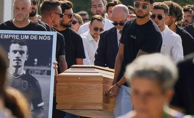 The coffins of Diogo Jota and his brother André Silva are carried into the church during their funeral in Gondomar, near Porto, Portugal, on Saturday, July 5, 2025. (AP Photo/Manu Fernandez)