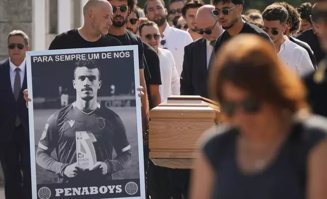 The coffins of Diogo Jota and his brother André Silva are carried into the church during their funeral in Gondomar, near Porto, Portugal, on Saturday, July 5, 2025. (AP Photo/Manu Fernandez)