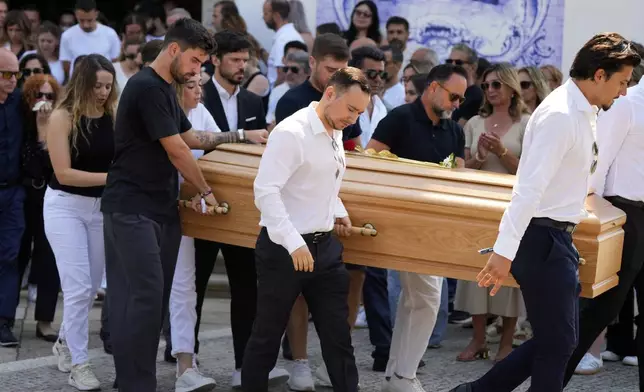 Diogo Jota's wife Rute Cardoso reacts next to the coffin of his husband, during his funeral in Gondomar, near Porto, Portugal, on Saturday, July 5, 2025. (AP Photo/Manu Fernandez)