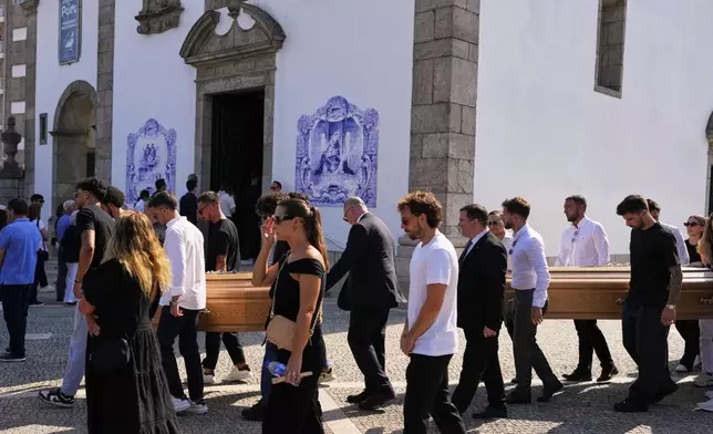 The coffins of Diogo Jota and his brother André Silva are carried outside the church during their funeral in Gondomar, near Porto, Portugal, on Saturday, July 5, 2025. (AP Photo/Manu Fernandez)