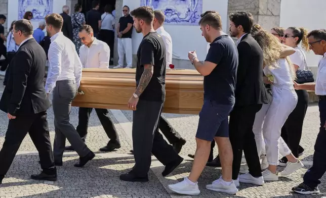 The coffins of Diogo Jota and his brother André Silva are carried outside the church during their funeral in Gondomar, near Porto, Portugal, on Saturday, July 5, 2025. (AP Photo/Manu Fernandez)