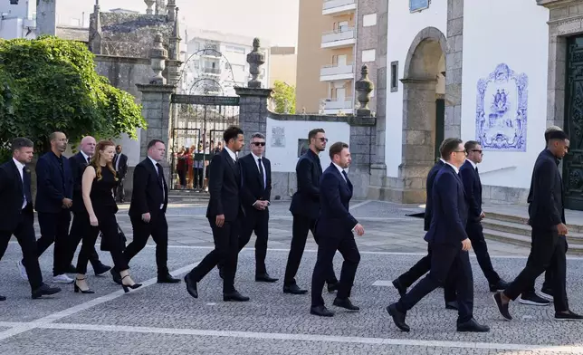 Liverpool players walk to the church to attend the funeral of their teammate Diogo Jota and his brother André Silva, in Gondomar, near Porto, Portugal, on Saturday, July 5, 2025. (AP Photo/Manu Fernandez)