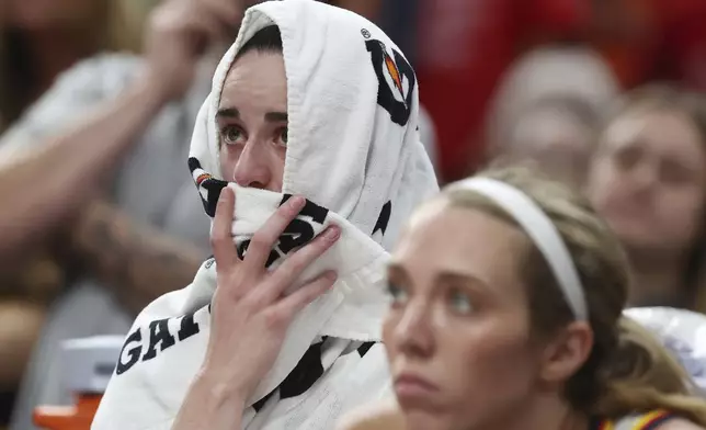 Indiana Fever's Caitlin Clark sits on the bench after an apparent injury during the second half of a WNBA basketball game against the Connecticut Sun, Tuesday, July 15, 2025, in Boston. (AP Photo/Michael Dwyer)