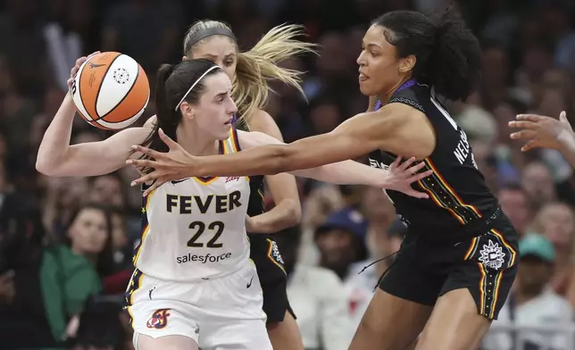 Connecticut Sun's Olivia Nelson-Ododa, right, defends against Indiana Fever's Caitlin Clark (22) during the second half of a WNBA basketball game, Tuesday, July 15, 2025, in Boston. (AP Photo/Michael Dwyer)