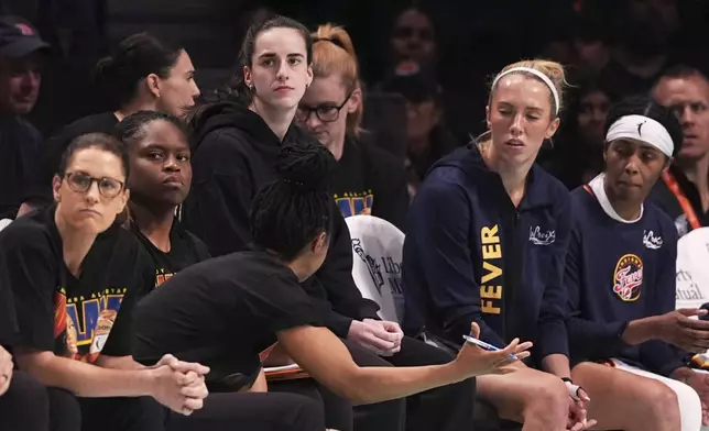 Indiana Fever's Caitlin Clark watches during the first half of a WNBA basketball game against the New York Liberty Wednesday, July 16, 2025, in New York. (AP Photo/Frank Franklin II)