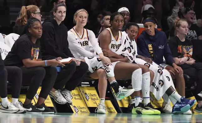 Indiana Fever's Caitlin Clark, third from left, and Sophie Cunningham react with teammates to a three-point shot by New York Liberty's Marine Johannes during the second half of a WNBA basketball game Wednesday, July 16, 2025, in New York. (AP Photo/Frank Franklin II)