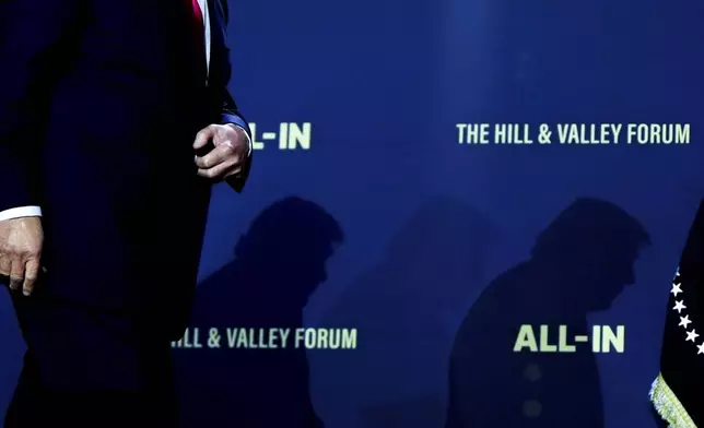 President Donald Trump walks to sign executive orders during an artificial intelligence summit at the Andrew W. Mellon Auditorium, Wednesday, July 23, 2025, in Washington. (AP Photo/Julia Demaree Nikhinson)