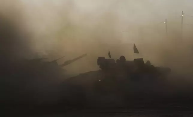 An Israeli military APC drives at a gathering point near the Gaza Strip, in southern Israel, July 21, 2025. (AP Photo/Ariel Schalit)