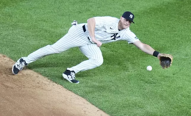New York Yankees' DJ LeMahieu dives for a ball hit by Athletics' Nick Kurtz for a single during the fifth inning of a baseball game Friday, June 27, 2025, in New York. (AP Photo/Frank Franklin II)