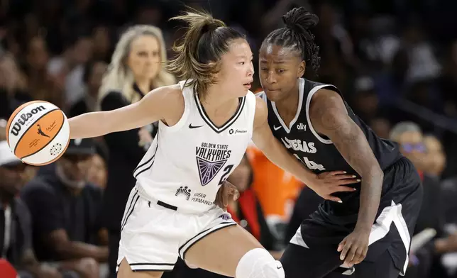 Golden State Valkyries guard Kaitlyn Chen (2) drives against Las Vegas Aces guard Jewell Loyd, right, during the first half of a WNBA basketball game Saturday, July 12, 2025, in Las Vegas. (Steve Marcus/Las Vegas Sun via AP)