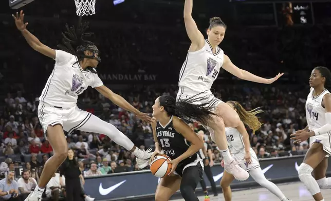 Golden State Valkyries guard Tiffany Hayes (15) and Golden State Valkyries forward Cecilia Zandalasini (24) defend against Las Vegas Aces guard Aaliyah Nye (13) during the first half of a WNBA basketball game Saturday, July 12, 2025, in Las Vegas. (Steve Marcus/Las Vegas Sun via AP)
