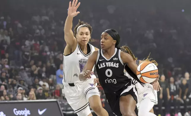 Las Vegas Aces guard Jackie Young (0) drives against Golden State Valkyries forward Janelle Salaun, left, during the first half of a WNBA basketball game Saturday, July 12, 2025, in Las Vegas. (Steve Marcus/Las Vegas Sun via AP)