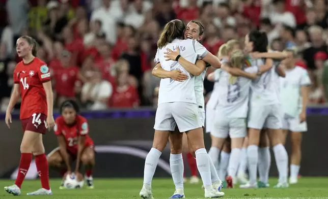 Norway's Marit B. Lund and Tuva Hansen, center right, celebrate at the end of the Euro 2025, group A, soccer match between Switzerland and Norway at St. Jakob-Park in Basel, Switzerland, Wednesday, July 2, 2025. (AP Photo/Martin Meissner)