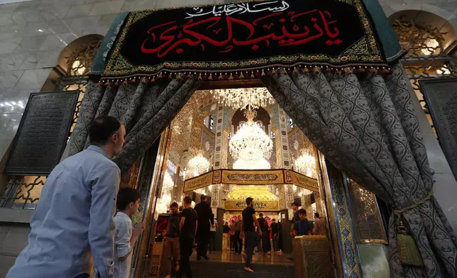 Shiite worshippers enter at the shrine of al-Sayydah Zeinab, the grand daughter of Prophet Mohammed, where they attend Ashoura ritual, south of Damascus, Syria, Thursday, July 3, 2025. (AP Photo/Omar Sanadiki)