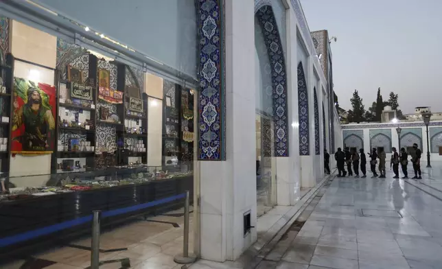 Syrian government security forces enter the shrine of al-Sayydah Zeinab, the grand daughter of Prophet Mohammed, where Shiite worshippers attend Ashoura ritual, south of Damascus, Syria, Thursday, July 3, 2025. (AP Photo/Omar Sanadiki)