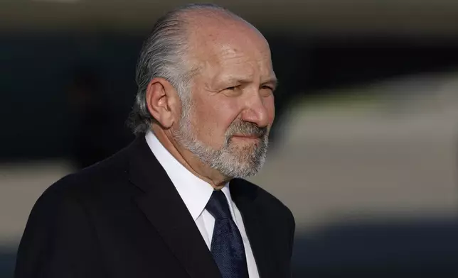 Secretary of Commerce Howard Lutnick walks away from Air Force One upon President Trump's arrival at Joint Base Andrews, Md., Tuesday, July 15, 2025. (AP Photo/Luis M. Alvarez)