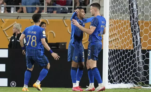 Al Hilal's Marcos Leonardo, centre, is congratulated by teammates after scoring his team's fourth goal during the Club World Cup round of 16 soccer match between Manchester City and Al Hilal in Orlando, Fla., Monday, June 30, 2025. (AP Photo/John Raoux)