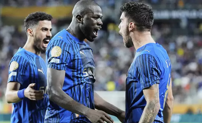 Al Hilal's Kalidou Koulibaly, centre, celebrates with teammates after scoring his team's third goal during the Club World Cup round of 16 soccer match between Manchester City and Al Hilal in Orlando, Fla., Monday, June 30, 2025. (AP Photo/John Raoux)