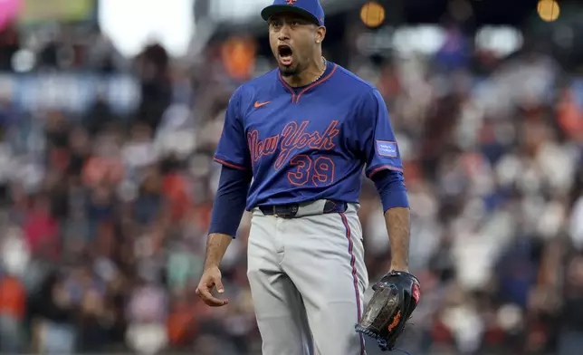 New York Mets pitcher Edwin Díaz celebrates against the San Francisco Giants during the ninth inning of a baseball game in San Francisco, Sunday, July 27, 2025. (AP Photo/Jed Jacobsohn)