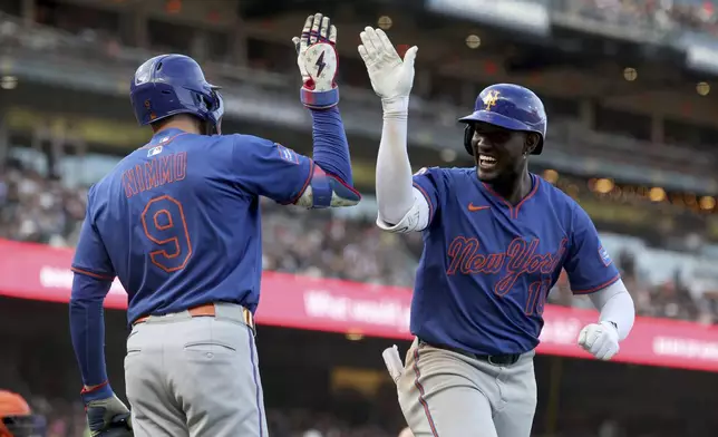 New York Mets' Ronny Mauricio, right, celebrates with Brandon Nimmo (9) after hitting a home run against the San Francisco Giants during the seventh inning of a baseball game in San Francisco, Sunday, July 27, 2025. (AP Photo/Jed Jacobsohn)