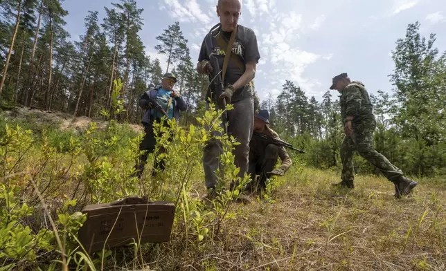 Civilians practice military skills on a training ground in Kharkiv, Ukraine, Saturday, July 12, 2025. (AP Photo/Andrii Marienko)