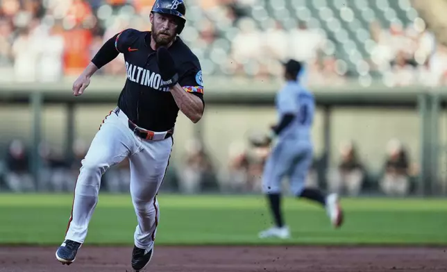 Baltimore Orioles' Jordan Westburg advances past third base to score on an RBI double hit by Ryan O'Hearn during the first inning of a baseball game against the Miami Marlins, Friday, July 11, 2025, in Baltimore. (AP Photo/Stephanie Scarbrough)