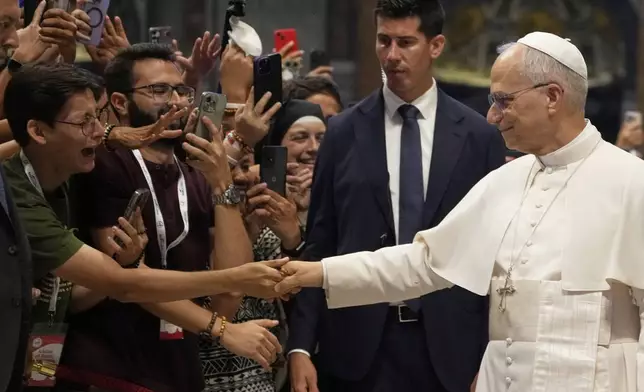 Pope Leo XIV greets faithful at the end of a mass celebrated by Cardinal Luis Antonio Tagle in St. Peter's Basilica on the occasion of the Youth Jubilee at the Vatican, Tuesday, July 29, 2025. (AP Photo/Gregorio Borgia)